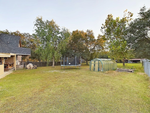 view of yard with an outbuilding and a trampoline