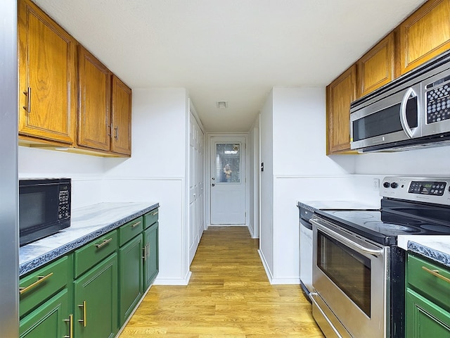 kitchen featuring light wood-type flooring and appliances with stainless steel finishes