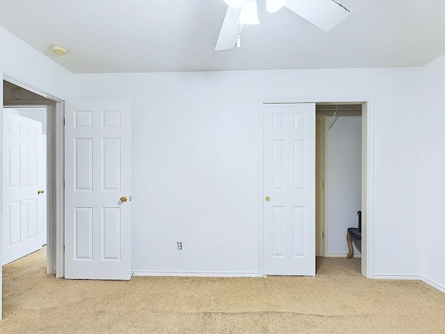 unfurnished bedroom with ceiling fan, carpet floors, and a closet