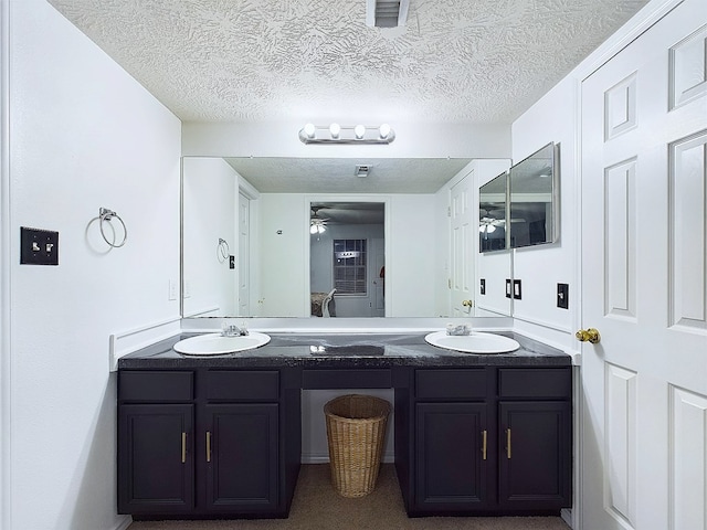 bathroom with vanity and a textured ceiling