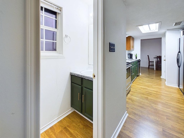 corridor featuring light hardwood / wood-style flooring and sink