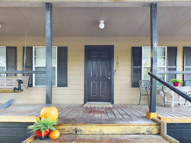 view of exterior entry with covered porch