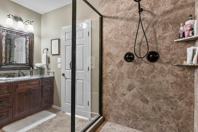 bathroom with a stall shower and vanity