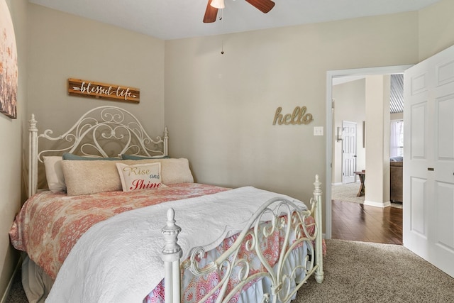 bedroom with ceiling fan, wood finished floors, and baseboards