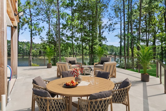 view of patio / terrace featuring outdoor dining area, a water view, and an outdoor hangout area