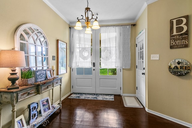 doorway featuring hardwood / wood-style floors, baseboards, crown molding, and french doors