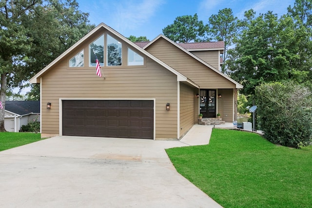 view of front of property featuring a garage, driveway, and a front lawn