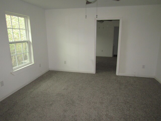 409 W 4th St, Hereford, TX 79045 - spare room featuring ceiling fan and dark carpet