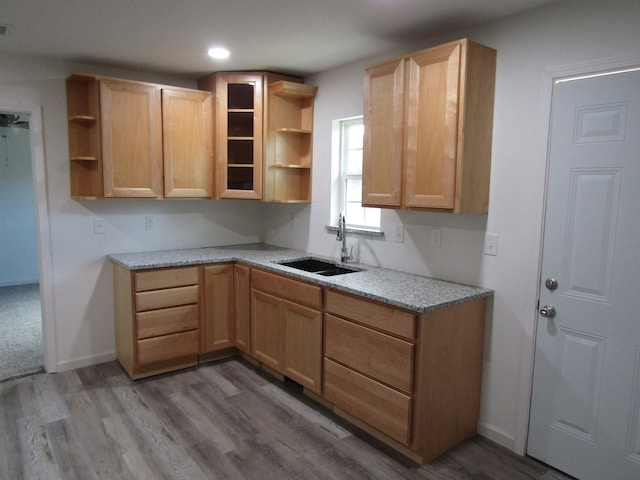 409 W 4th St, Hereford, TX 79045 - kitchen featuring light hardwood / wood-style floors, sink, and light brown cabinetry