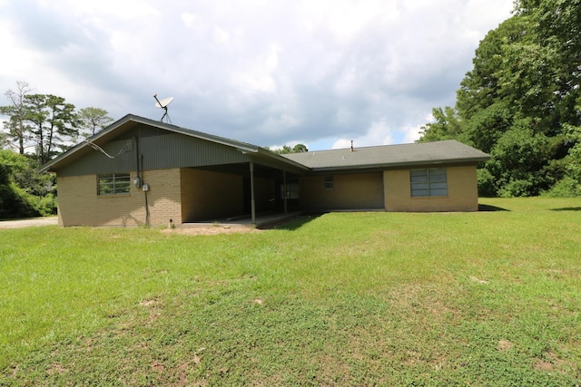 rear view of property with a yard