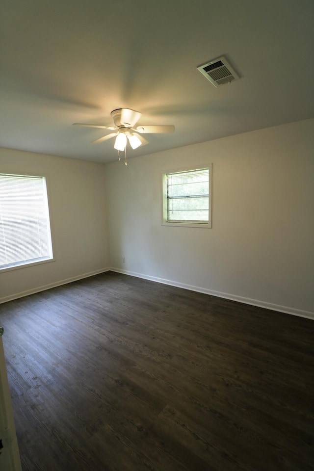 unfurnished room featuring ceiling fan and dark wood-type flooring