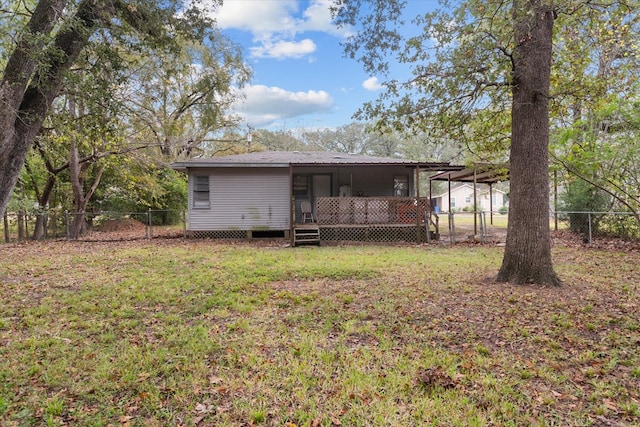 back of house with a lawn