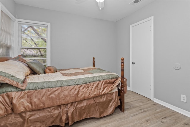 bedroom with ceiling fan and light wood-type flooring