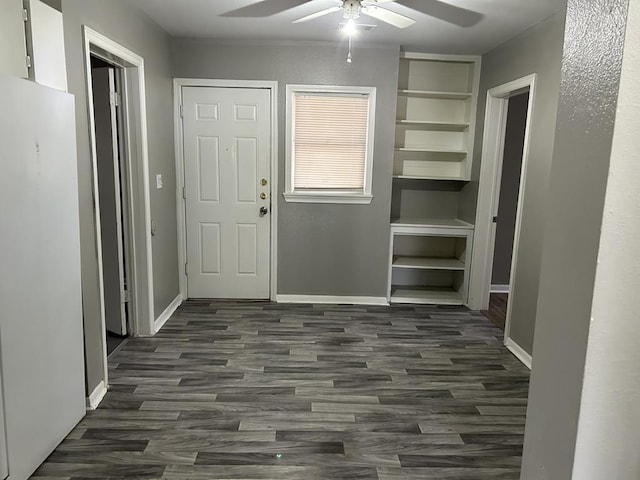 foyer entrance featuring dark wood-type flooring and ceiling fan