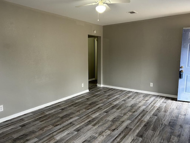 spare room featuring dark hardwood / wood-style flooring and ceiling fan