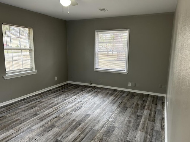 empty room featuring dark wood-type flooring and ceiling fan