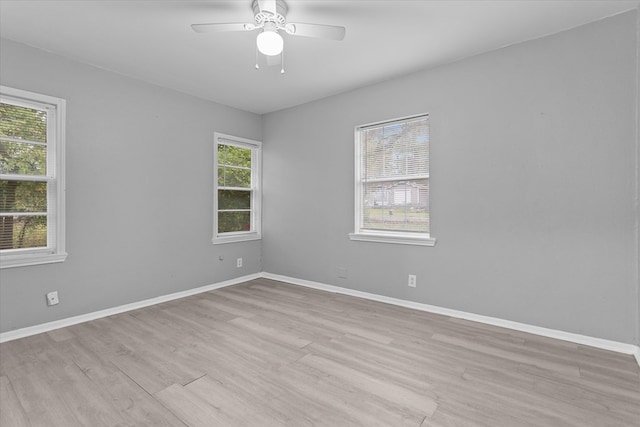 spare room featuring light hardwood / wood-style floors and ceiling fan