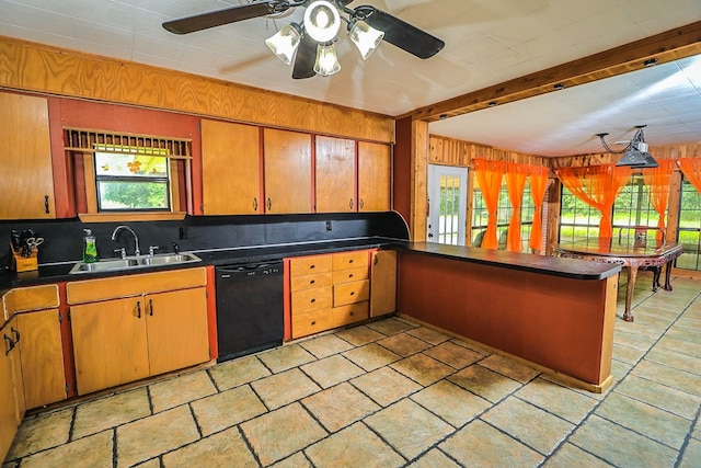 303 W Stringer, Kirbyville, TX 75956 - kitchen featuring dishwasher, a sink, dark countertops, wood walls, and decorative backsplash