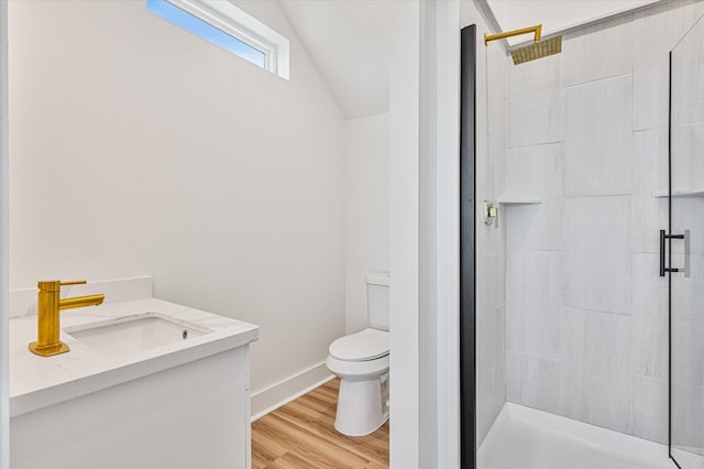 full bathroom featuring a sink, toilet, a shower stall, vaulted ceiling, and wood finished floors