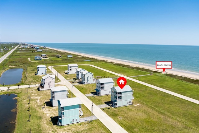 drone / aerial view with a water view and a view of the beach
