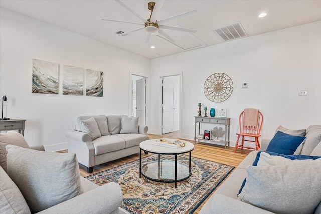 living room with light wood-style floors, ceiling fan, visible vents, and recessed lighting