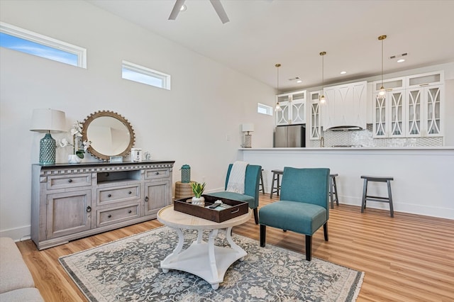 sitting room featuring light wood-style flooring, baseboards, a ceiling fan, and recessed lighting