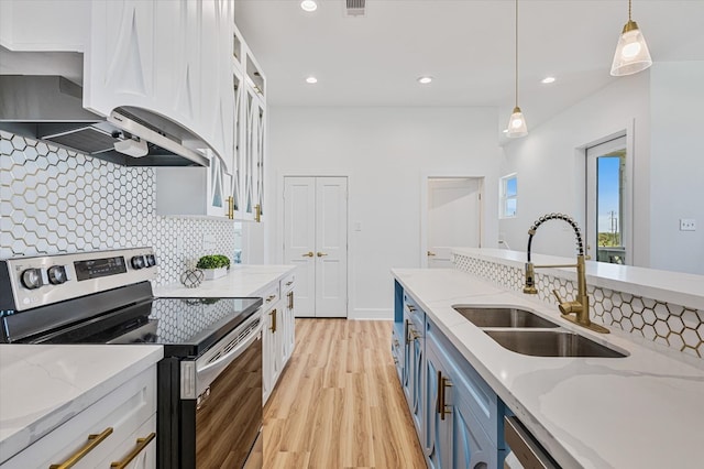 kitchen with white cabinets, a sink, light wood-style floors, blue cabinetry, and electric range