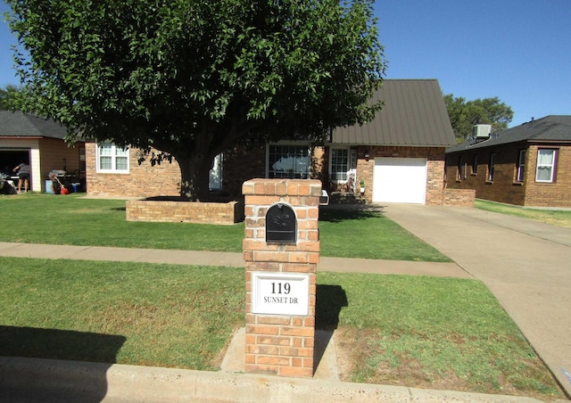 view of front of house with a front lawn and a garage