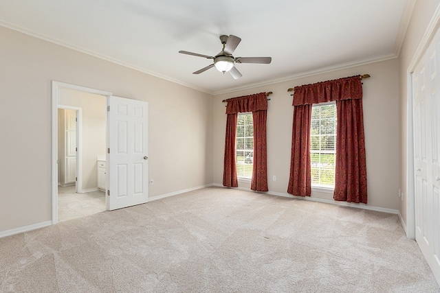 carpeted spare room with ceiling fan and ornamental molding