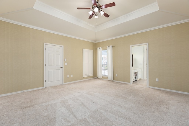 spare room featuring ceiling fan, crown molding, and a tray ceiling