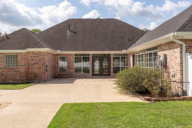 rear view of house with a lawn