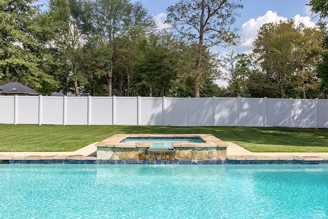 view of swimming pool featuring a lawn and an in ground hot tub