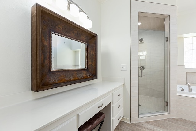 bathroom with vanity, independent shower and bath, and hardwood / wood-style flooring