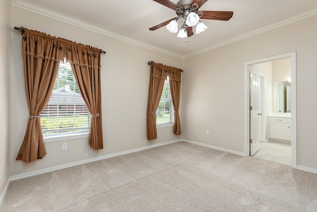 carpeted empty room with ceiling fan and ornamental molding