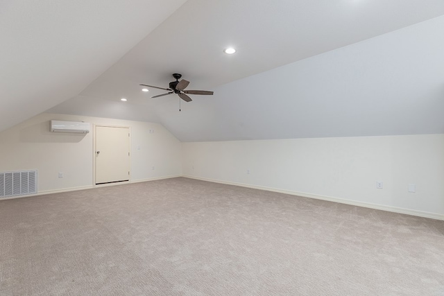 additional living space with ceiling fan, light colored carpet, lofted ceiling, and a wall unit AC