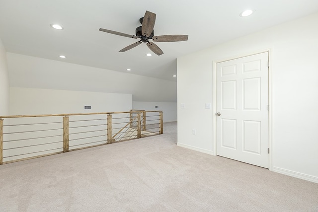 bonus room featuring ceiling fan, lofted ceiling, and light carpet