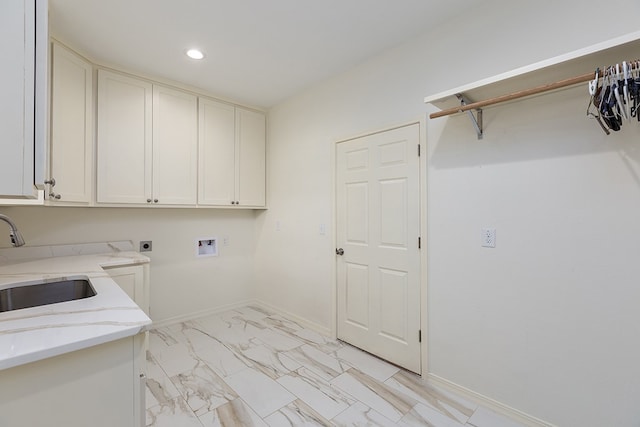 clothes washing area featuring hookup for an electric dryer, cabinets, sink, and hookup for a washing machine