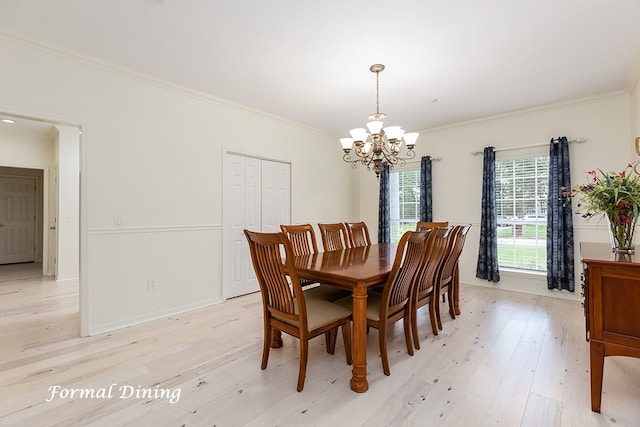 dining area with crown molding, an inviting chandelier, and light wood-type flooring