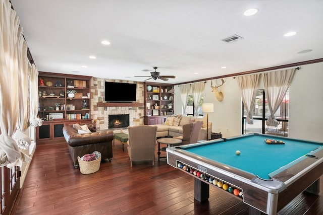 rec room featuring ceiling fan, a stone fireplace, dark wood-type flooring, and billiards