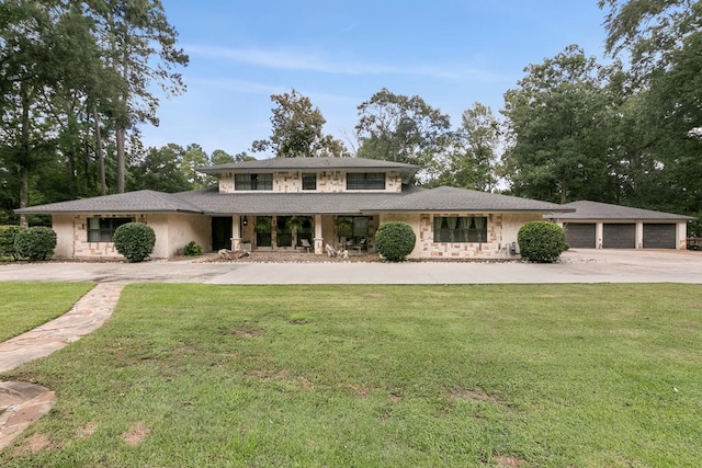 view of front of home with a garage and a front yard