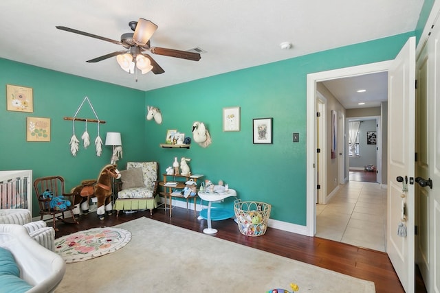 bedroom with hardwood / wood-style floors and ceiling fan