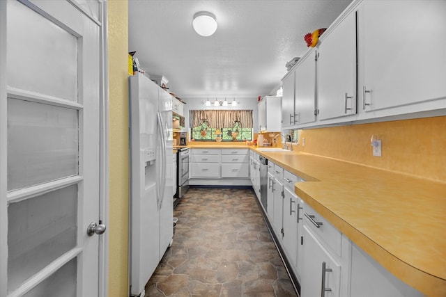 kitchen featuring a textured ceiling, sink, white cabinetry, and stainless steel appliances