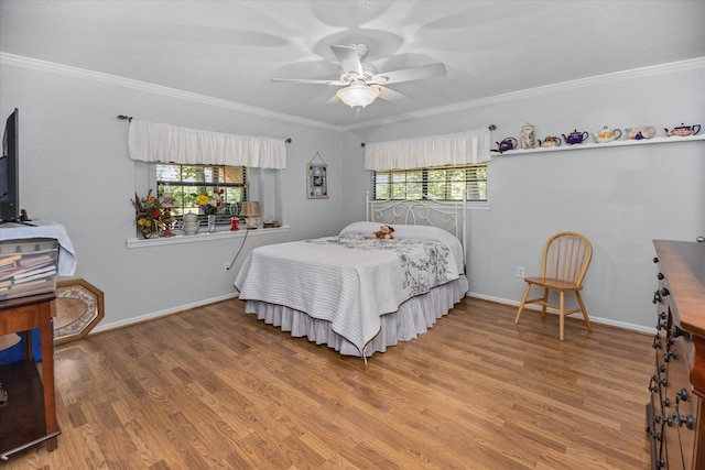 bedroom featuring ceiling fan, wood-type flooring, and ornamental molding