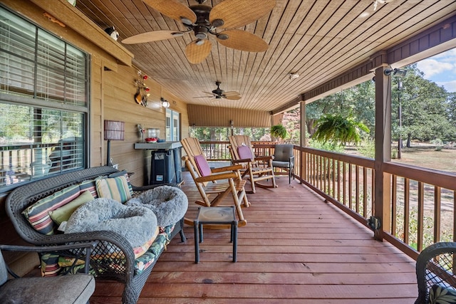 deck with a porch and ceiling fan