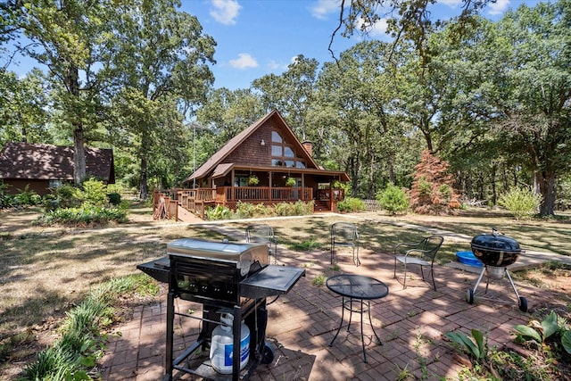 view of patio featuring area for grilling, a fire pit, and a wooden deck