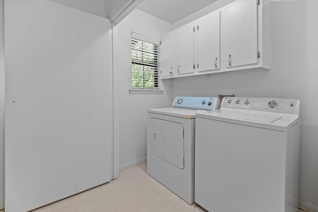 washroom featuring cabinets and independent washer and dryer