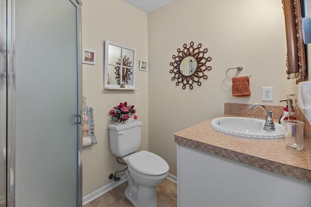 bathroom with toilet, vanity, and tile patterned floors