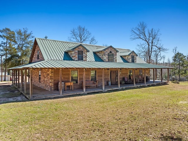 rear view of house featuring a porch, a lawn, and metal roof