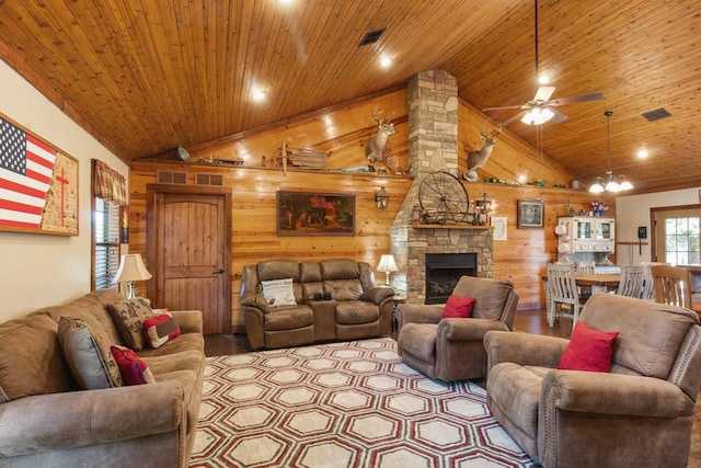 living area featuring a fireplace, wooden walls, wood ceiling, and visible vents