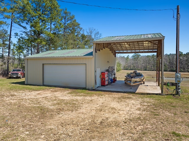 garage with dirt driveway